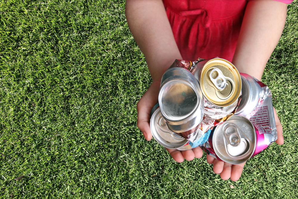 Aluminum cans crushed and ready to be recycled showing recycling facts