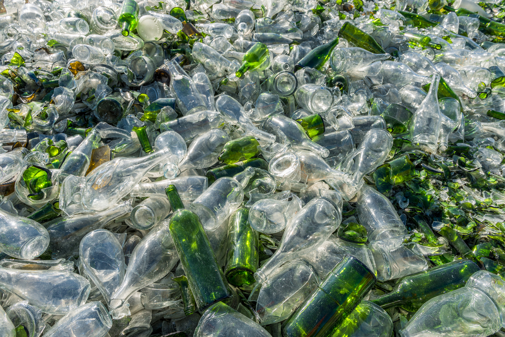 Clear and green glass bottles ready to be recycled